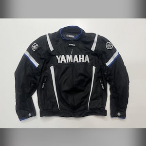 May include: A white ceramic mug with a black handle and the text "But First, Coffee" in a black, bold font. The mug is on a white surface. The mug is 4 inches tall.