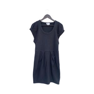 May include: A dark gray dress with a scoop neckline and short, puffed sleeves. The dress features a fitted bodice and a pleated skirt, hanging on a black hanger against a white background. The dress is made of a soft, textured fabric.