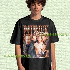 May include: Black t-shirt featuring a collage of images of Patrick Wilson with the name "PATRICK Wilson" in a copper-colored font. The shirt has a vintage, retro style.