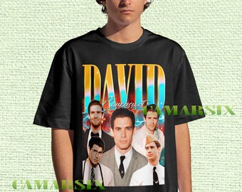 May include: Black t-shirt featuring a collage of images and the name "DAVID" in gold and blue. The shirt has a vintage aesthetic, with multiple portraits of a man in various outfits.