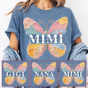May include: A blue t-shirt with a butterfly design. The butterfly wings are made of patchwork in pastel shades. The word "MIMI" is displayed in white, with names underneath. Three other butterfly designs are shown with the words "GIGI", "NANA", and "MIMI".