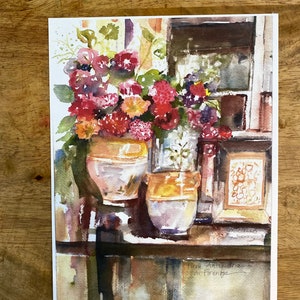 May include: Watercolor painting of a still life featuring a bouquet of red, pink, and purple flowers in two ceramic pots on a wooden table. The painting is signed "Fiera Antiquaria di Firenze" in the bottom right corner.