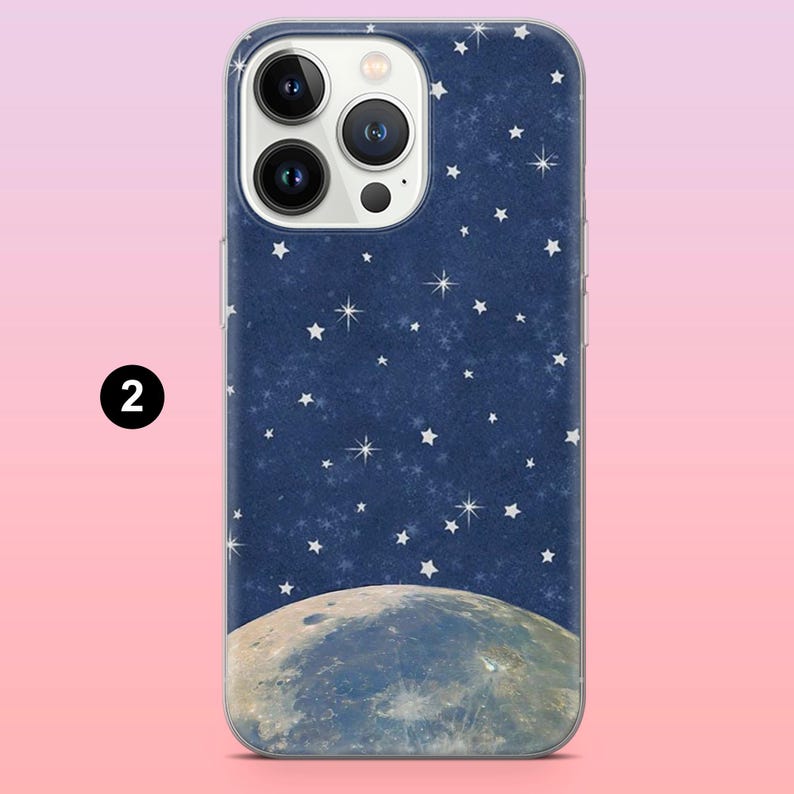 May include: A phone case featuring a night sky design. The case has a dark blue background with white stars and a detailed illustration of the moon. The number "2" is printed on the side of the case.