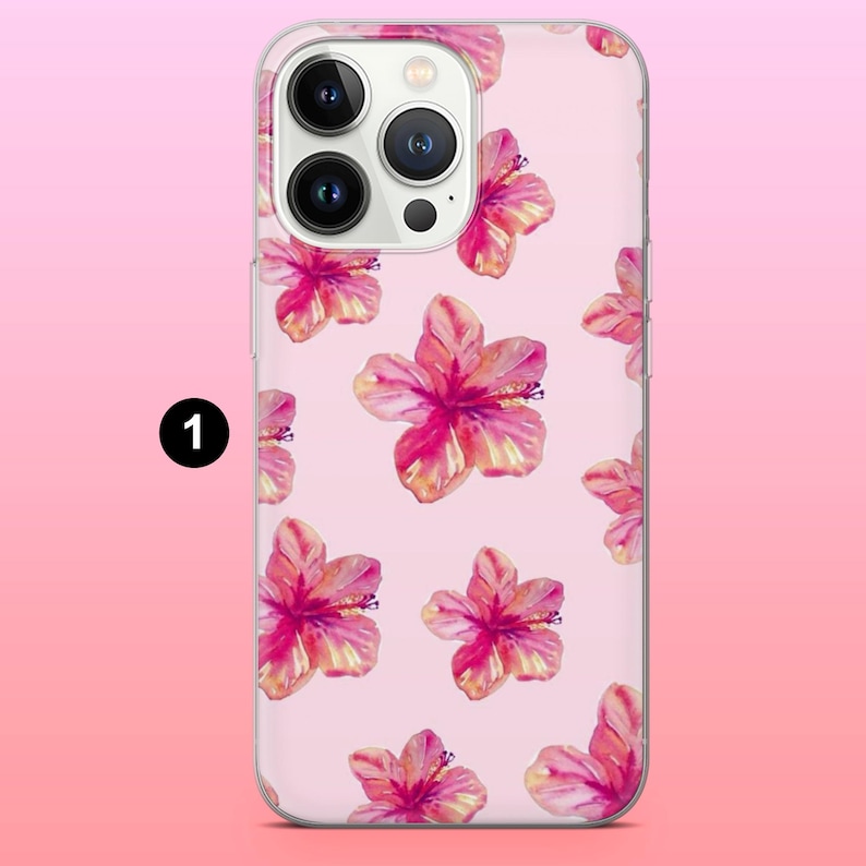 May include: A clear phone case featuring a pink hibiscus flower pattern. The case has a light pink background and a clear border. The flowers are in shades of pink, red, and yellow.
