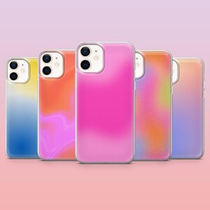 May include: Five mobile phone cases with a gradient design in various colours. The cases include yellow, orange, pink, purple, and mixed hues. Each case has a clear border and a camera aperture.