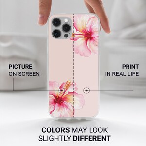 May include: A clear phone case featuring a watercolor design of pink hibiscus flowers. The case has a light pink background. Text on the case reads "PICTURE ON SCREEN" and "PRINT IN REAL LIFE". The text "COLORS MAY LOOK SLIGHTLY DIFFERENT" is also visible.