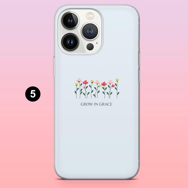 May include: A light blue phone case featuring a floral design with pink, red, and yellow flowers. The phrase "GROW IN GRACE" is printed below the flowers. The case has a glossy finish and a camera cutout.