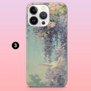 May include: A clear phone case with a floral design featuring a white bird in flight. The flowers are in shades of purple, pink, and white. The case has a camera lens cutout and a clear back.