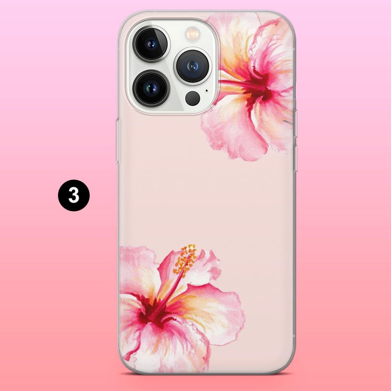 May include: A phone case with a pink hibiscus flower design. The case has a light pink background and features two watercolor-style hibiscus flowers in shades of pink and yellow. The phone case has a clear border.