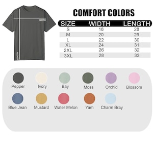 May include: A dark gray t-shirt with size and color options. The image includes a size chart with measurements in inches and a color palette featuring shades like pepper, ivory, and blue jean. The text "COMFORT COLORS" is at the top.