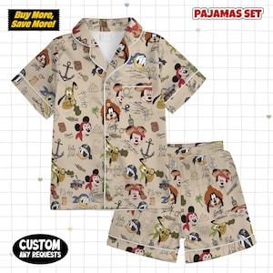 May include: Beige pajama set with a pattern of Disney characters, anchors, and pirate-themed elements. The set includes a short-sleeved button-up shirt and matching shorts. Text on the image includes "PAJAMAS SET" and "Buy More, Save More!"