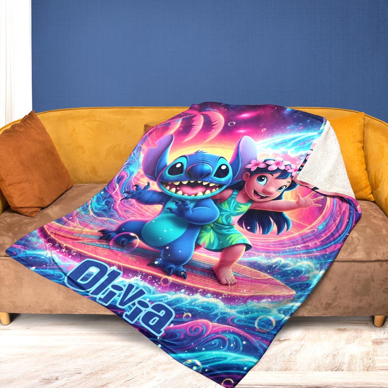 May include: A colorful blanket featuring the characters Stitch and Lilo from the Disney movie Lilo & Stitch. The blanket has a vibrant design with the name "Olivia" printed on it. The blanket is displayed on a yellow sofa.