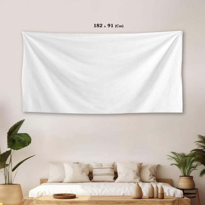 May include: A large, white rectangular tapestry, measuring 182 x 91 cm, hangs on a wall. The fabric is draped, creating soft folds. The tapestry is a neutral color, suitable for various interior design styles.