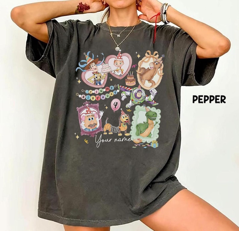 May include: Dark gray t-shirt featuring cartoon characters in heart-shaped frames, a birthday cake, and the text "Your name". The shirt also has the number 4 and the word "Pepper" printed on it.