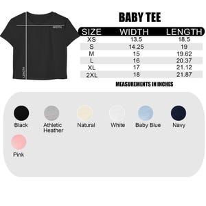 May include: Black baby tee shirt with size chart. The chart shows measurements in inches for sizes XS to 2XL. Available colors include black, athletic heather, natural, white, baby blue, navy, and pink.