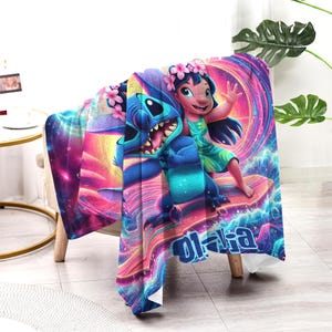 May include: A colorful blanket featuring the characters Stitch and Lilo from the animated movie. The blanket has a vibrant design with a swirling background of pink, purple, and blue. The word "O'hana" is written in blue.