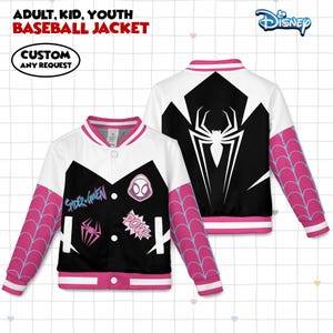 May include: A white, black, and pink baseball jacket with the text "Spider-Gwen" and various graphic patches. The sleeves feature a pink spiderweb design. The back of the jacket displays a large white spider graphic on a black background. The jacket is for adults, kids, and youth.