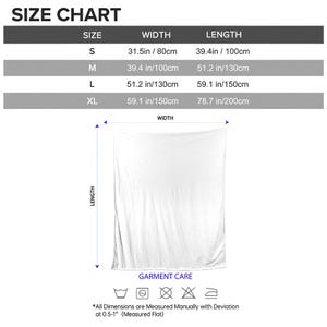May include: A white blanket with a size chart. The chart shows sizes S, M, L, and XL, with corresponding widths and lengths in inches and centimeters. The blanket's dimensions are measured flat. Garment care symbols are also included.
