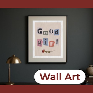 May include: Framed wall art with the words "Good Girl" in a collage style, with each letter in a different color. A dried rose lies below the text. The words "Wall Art" are at the bottom.