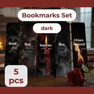 May include: A set of five dark-themed bookmarks. Each bookmark features gothic imagery, including roses, skulls, and flames. The bookmarks have various phrases written on them, such as "Good girl" and "I'd burn the world for you."