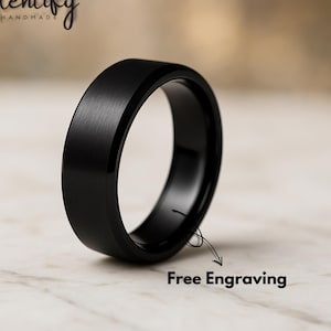 May include: A black ring with a brushed metal finish. The ring has a flat top and beveled edges. The text "Free Engraving" is included in the image. The brand name "Glentify Handmade" is also visible.