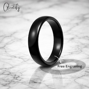 Könnte beinhalten: Ein glänzender schwarzer Ring mit abgerundetem Profil. Der Ring befindet sich auf einer Oberfläche mit Marmormuster. Der Text "Free Engraving" wird in der Nähe des Rings angezeigt. Der Markenname "Glentify Handmade" befindet sich in der oberen linken Ecke.