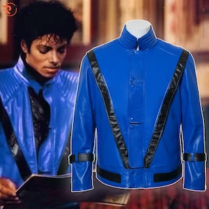 May include: A vibrant blue jacket with black accents. The jacket features a stand-up collar, a button-up front, and black stripes running down the front. The sleeves have black straps at the cuffs. The jacket is a bold fashion statement.