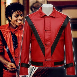 May include: A red leather jacket with black accents, featuring a V-shaped design on the front and black stripes on the shoulders. The jacket has a button-up closure and a band around the waist and cuffs.