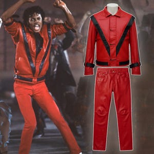 May include: A red leather jacket and matching pants set. The jacket features black stripes on the shoulders and sleeves. The pants are a straight-leg style. The outfit is displayed on a mannequin and is reminiscent of a famous performer's iconic look.