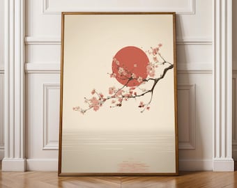 May include: A rectangular wall art print in a wooden frame featuring a horizontal cherry blossom branch with pink flowers extending across a large red circular sun, set against a pale cream background with a subtle horizon line at the bottom.