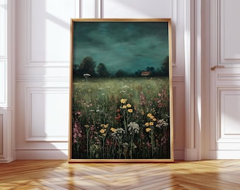 May include: A framed art print of a field of wildflowers under a dark, moody sky. The painting features yellow, pink, and white flowers, with a small house visible in the distance. The frame is a light wood color.