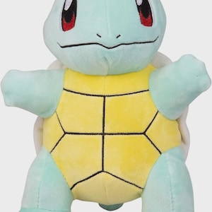 May include: A plush toy of the Pokemon Squirtle. The toy is green and yellow and has a shell on its back. It has big eyes and a small mouth.