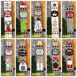 Peut inclure: Une collection de panneaux de No&euml;l en bois avec divers motifs festifs. Chaque panneau pr&eacute;sente des &eacute;l&eacute;ments sur le th&egrave;me des f&ecirc;tes comme un bonhomme de neige, un renne, un sapin de No&euml;l et le P&egrave;re No&euml;l, ainsi que des v&oelig;ux de saison. Les panneaux sont peints en couleurs vives.