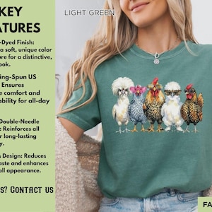 May include: A light green short-sleeve t-shirt featuring a graphic print of five chickens standing in a row. The chickens are depicted with various feather patterns and colors, including white, grey, and brown, with some wearing decorative glasses.