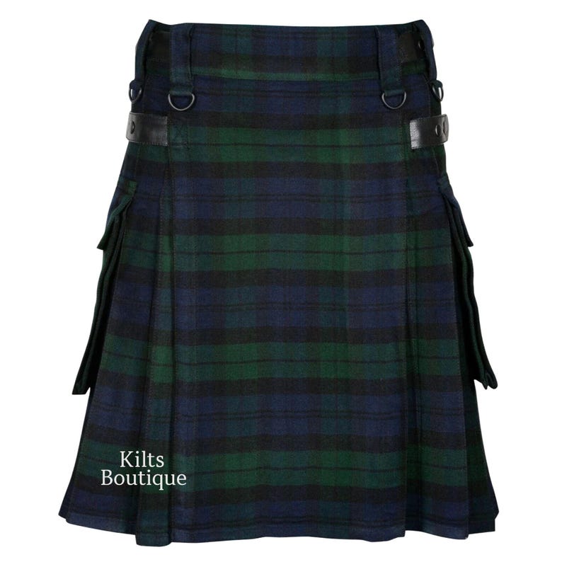 May include: A traditional kilt in a green, navy, and black plaid pattern. The kilt features leather straps with metal buckles and D-rings. The words "Kilts Boutique" are printed on the lower left side.
