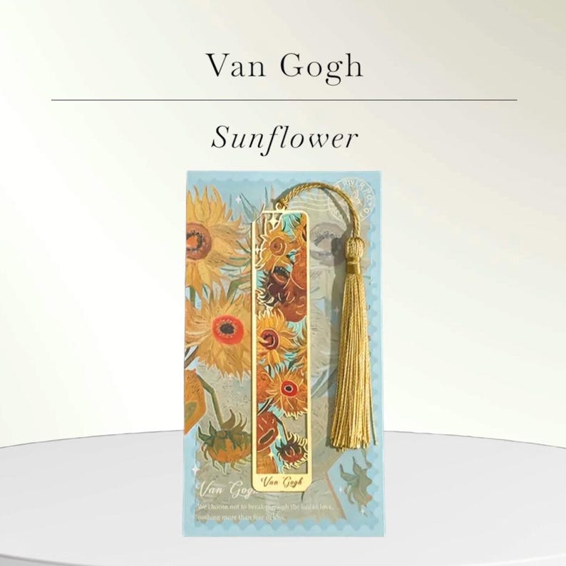 May include: A gold-colored metal bookmark featuring a sunflower design, with a matching gold tassel. The bookmark is set against a light blue background with a sunflower painting. The text "Van Gogh Sunflower" is at the top.
