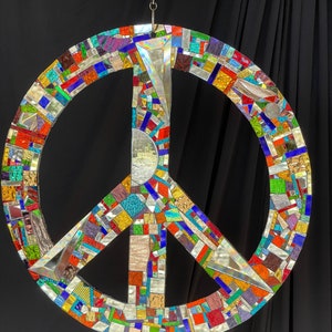 Dazzling 16” mirror mosaic peace sign sun catcher, hang inside or outside. Steel center covered in silver and colored mirror bits