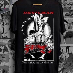 May include: Black t-shirt with a white graphic of a demon character from the anime Devilman. The graphic includes the text "Devilman" and "Step inside, see the devil in I".