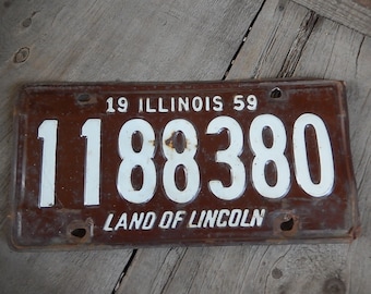 May include: A brown metal license plate with white lettering. The plate reads "19 ILLINOIS 59" and "118380" with the text "LAND OF LINCOLN" at the bottom.