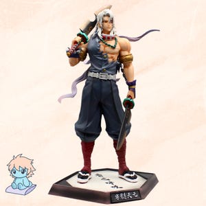 May include: A detailed figurine of a character with white hair, wearing a torn blue vest, dark blue trousers, and red leg warmers. The figure holds two swords and is adorned with gold and green accessories. The base has Japanese text.