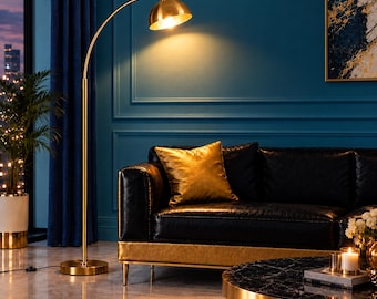 May include: A tall, arched floor lamp with a brushed gold finish and a dome-shaped shade. The lamp features a slender vertical pole, a circular base, and a curved arm that extends to position the light source directly over the seating area.