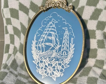 Anchored in Time – Etched Tattoo-Style Sailboat & Lighthouse Mirror | Nautical Wall Decor | Gold Frame | Traditional Flash Art |
