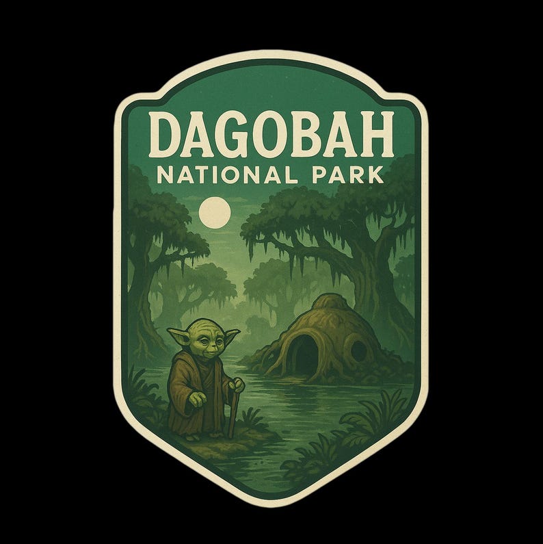 May include: A green and beige Dagobah National Park sticker featuring Yoda with a walking stick, standing in front of a swampy landscape with a full moon. The sticker has a vintage, illustrated style.