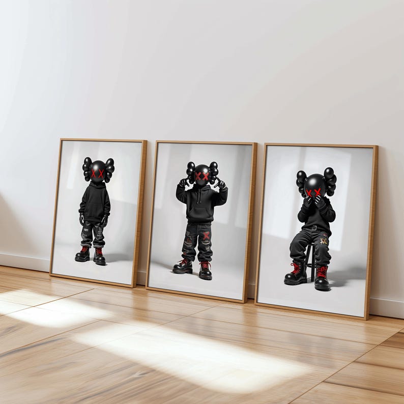 May include: Three framed prints of black and white figures with red X's for eyes. The figures are wearing black hoodies and pants. The figure on the left is standing, the figure in the middle is standing with hands on head, and the figure on the right is sitting on a stool.