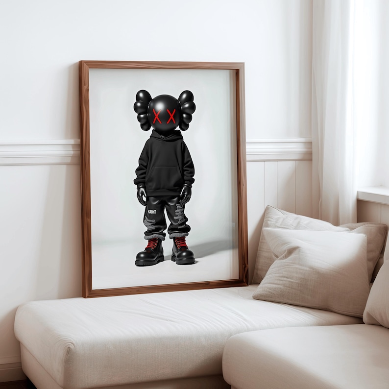 May include: A black and white figurine of a character wearing a black hoodie and black and white pants. The character has a large head with red X's for eyes. The figurine is standing on a white background.