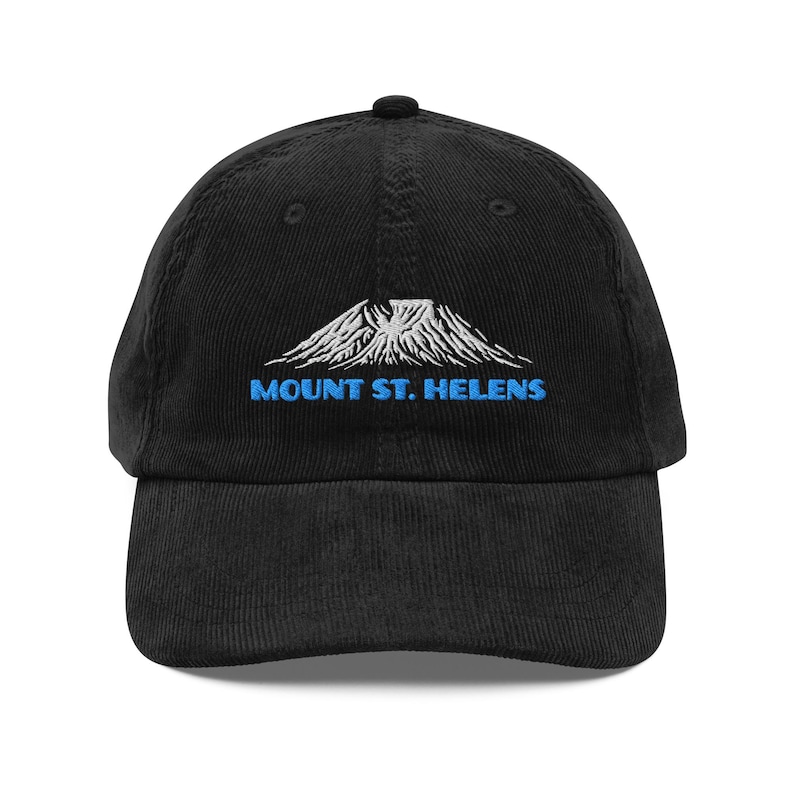 May include: Black corduroy baseball cap with a curved brim. The cap features an embroidered design of Mount St. Helens in white and blue, with the text "MOUNT ST. HELENS" in blue below the mountain.