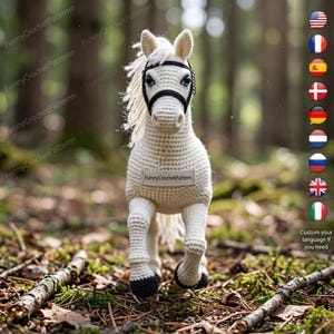 May include: A handmade, off-white crochet horse with a black bridle and black hooves. The horse has a white mane and tail. The text "FunnyCrochetPattern" is on the horse's body. The horse is standing on a bed of leaves and twigs.