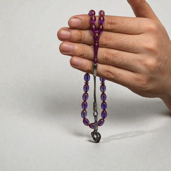 Handmade purple Baltic-style resin prayer beads adorned with 1000 silver Kazaz tassels.