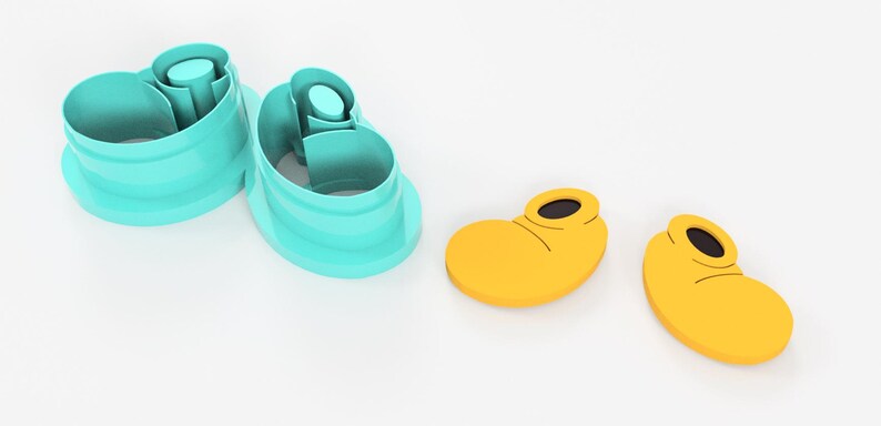 May include: A set of two teal shoe-shaped cookie cutters and two yellow shoe-shaped cookie cutters with black details. The cutters are designed to create cookies in the shape of cartoon shoes.