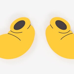 May include: Two yellow cartoon shoes with black oval openings and black curved lines. The shoes are a bright yellow color and are set against a white background. The shoes are a whimsical design.